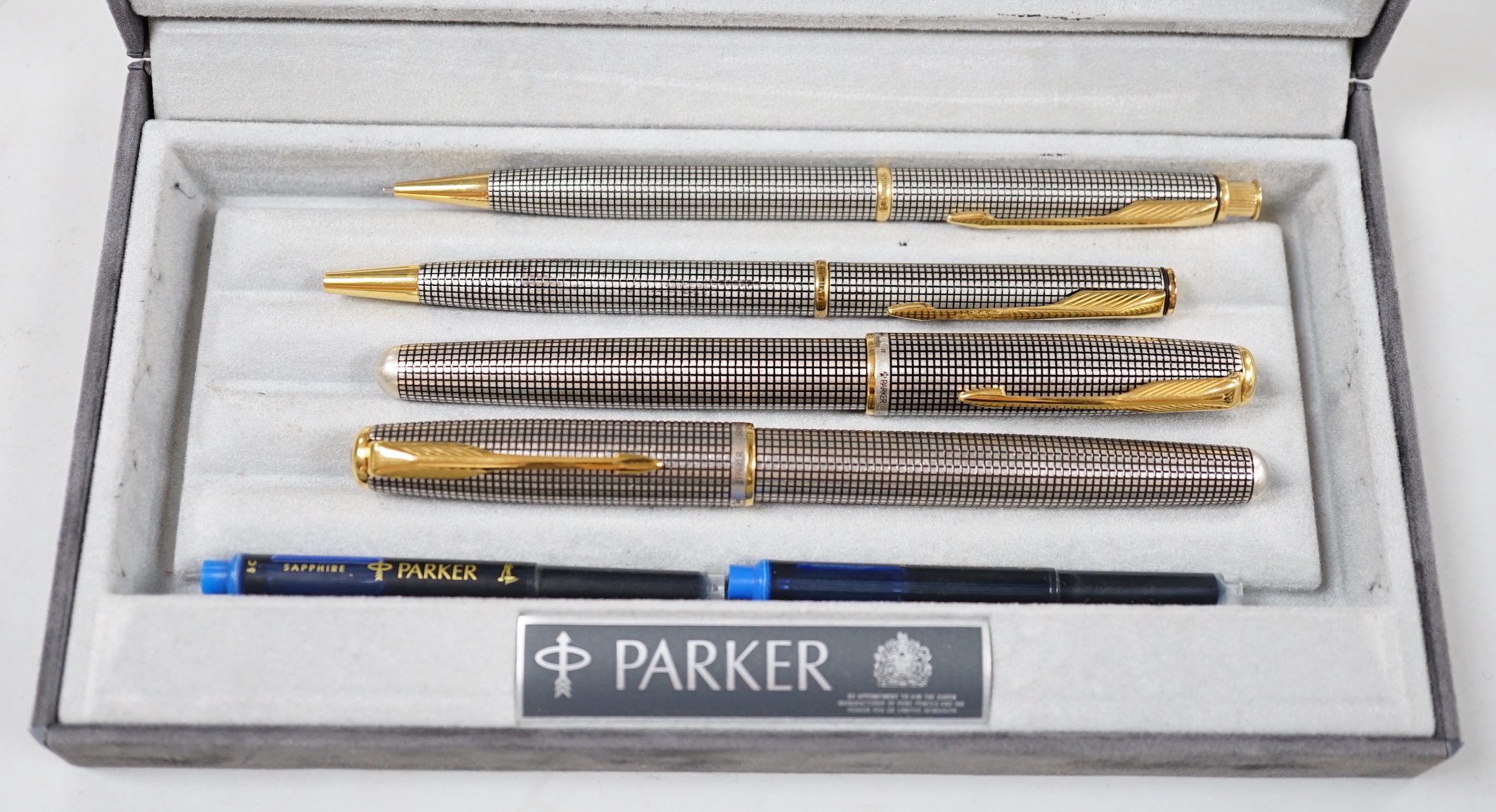 Two Parker Sonnet silver fountain pen/ballpoint pen sets in a Parker Duofold box